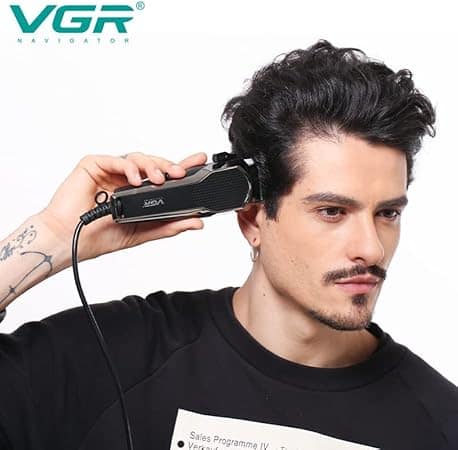 Achieve professional salon-grade precision at home with the VGR V-130 Hair Clipper, available with a 1-year warranty. Designed for both barbershop professionals and personal use in Sri Lanka, this high-performance trimmer ensures a smooth and seamless grooming experience. Whether you're perfecting fades, designing sharp haircuts, or trimming beards, mustaches, and necklines, this clipper is your ideal grooming tool. Key Features: Powerful Motor: Equipped with a 10W professional motor, it delivers strong cutting power with less noise (under 50dB), making it perfect for both home use and professional settings. Self-Sharpening Precision Blades: High-quality carbon-steel blades ensure long-lasting sharpness and precise cuts, while preventing skin irritation. T-Blade Design: Ideal for fades, detailing, and outlining, the close-cutting T-Blade provides extreme precision. 4 Attachment Guards: Achieve a variety of hairstyles and lengths with 4 guide combs (3mm, 6mm, 9mm, 12mm), making it versatile for both hair and beard trimming. Low Noise and Comfort: Specially designed to provide a quiet cutting experience, perfect for children and the elderly. Waterproof Blades: Easy to clean, simply rinse the blades under water after trimming for hassle-free maintenance. Why It’s Perfect for Sri Lanka: Whether you're looking to achieve a fresh look in the hot and humid climate of Sri Lanka or style your hair and beard for any occasion, the VGR V-130 Hair Clipper offers reliable performance with precision and convenience. Its powerful motor and durable build ensure that it can handle a variety of hair textures and styles, catering to the diverse grooming needs in Sri Lanka. Available at Trontronics.lk, this VGR V-130 Hair Clipper is the perfect addition to your grooming kit.